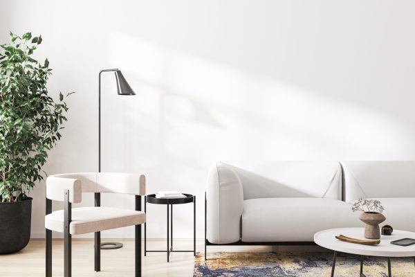 White armchair and sofa in modern living room interior with white wall and sunlight, 3d rendering